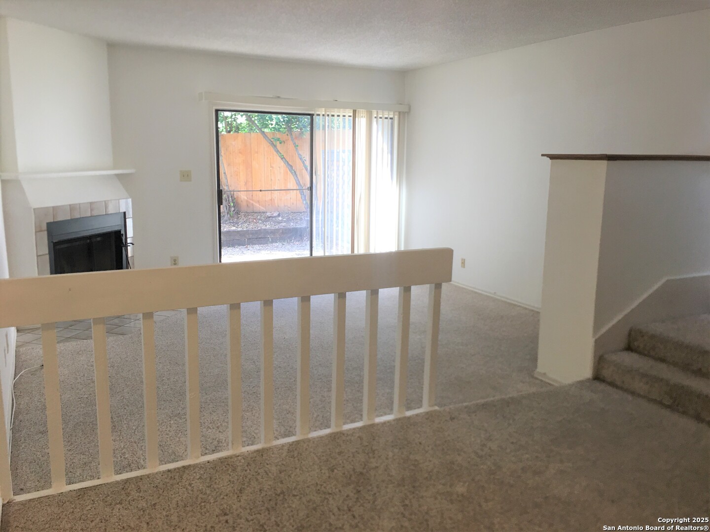 11815 Vance Jackson Road, Unit 1804 San Antonio, TX 78230 - Photo 4 of 10 a view of a porch with wooden floor and fireplace