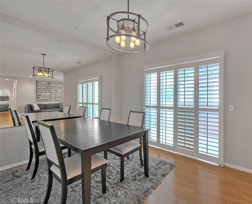 11450 Church Street, Unit 63 Rancho Cucamonga, CA 91730 - Photo 15 of 52 a view of a dining room with furniture window and wooden floor