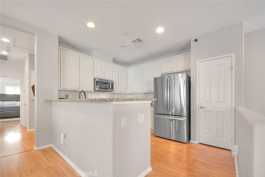 11450 Church Street, Unit 63 Rancho Cucamonga, CA 91730 - Photo 21 of 52 a kitchen with stainless steel appliances granite countertop a refrigerator and a stove