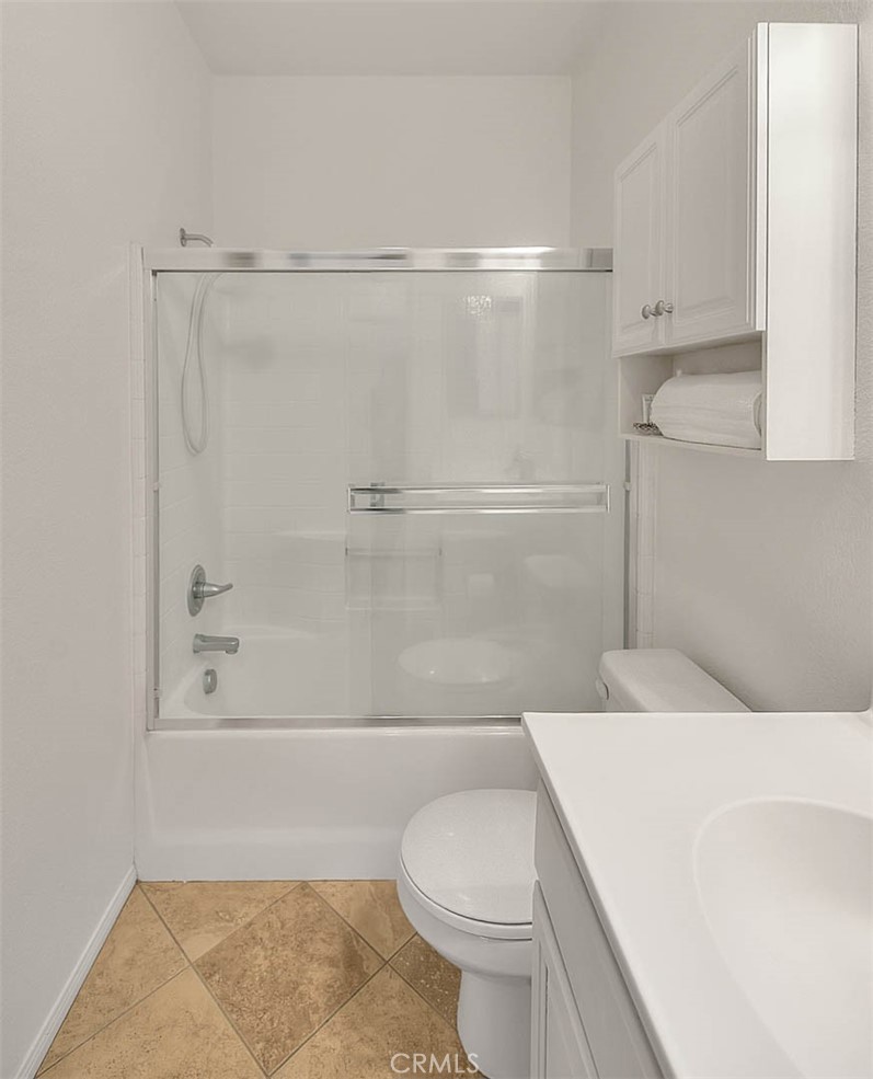 11450 Church Street, Unit 63 Rancho Cucamonga, CA 91730 - Photo 29 of 52 a bathroom with a shower a toilet and a sink