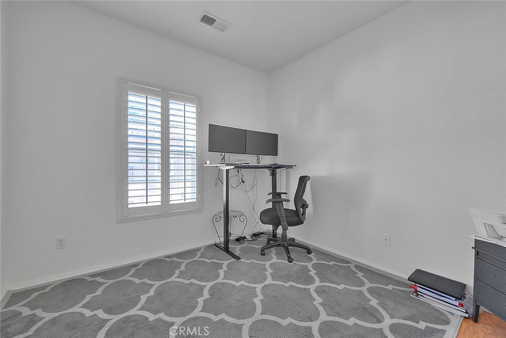 11450 Church Street, Unit 63 Rancho Cucamonga, CA 91730 - Photo 34 of 52 a view of a workspace with furniture and a window