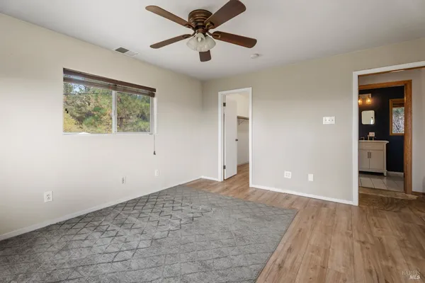 a view of a big room with wooden floor and windows in a room