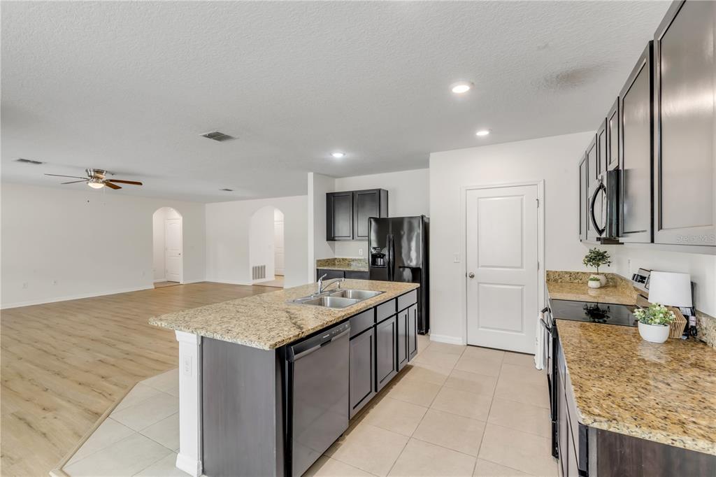 48 Hickory Loop Ocala, FL 34472 - Photo 21 of 52 a kitchen with stainless steel appliances granite countertop a sink stove and refrigerator