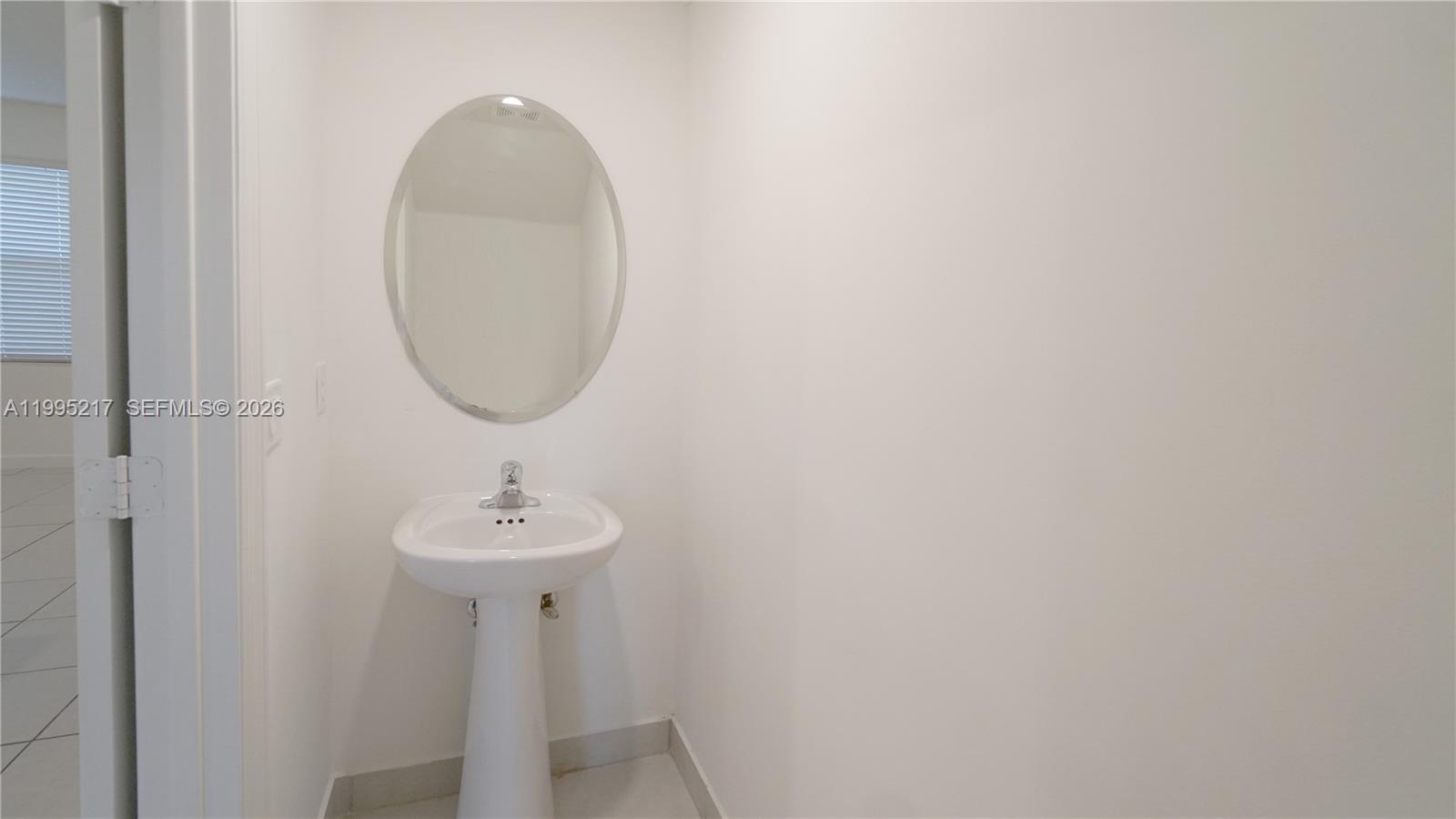 11870 Southwest 246th Street Homestead, FL 33032 - Photo 27 of 31 a bathroom with a sink and a mirror