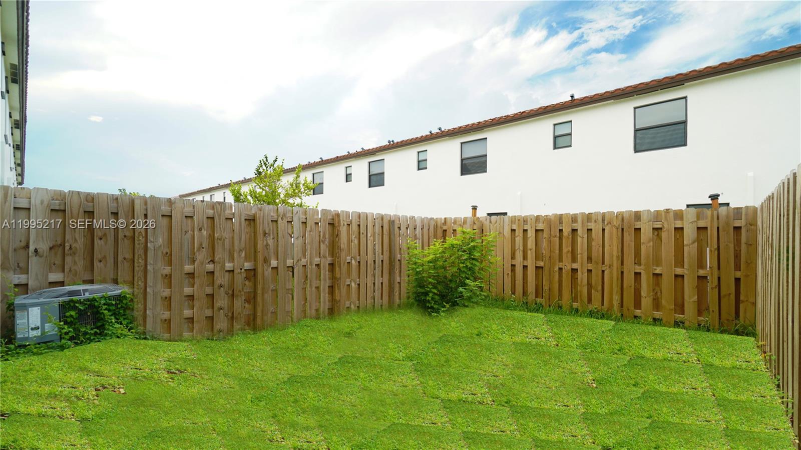 11870 Southwest 246th Street Homestead, FL 33032 - Photo 31 of 31 a view of a backyard with potted plants and wooden fence