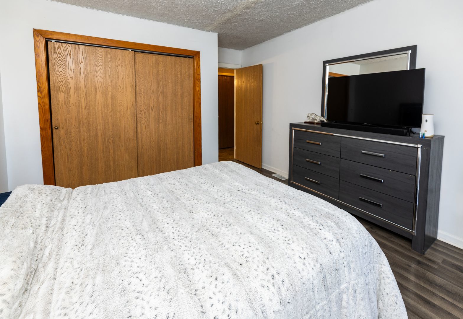902 Kenneth Circle, Unit 6 Elgin, IL 60120 - Photo 12 of 24 a bedroom with a bed and a flat screen tv