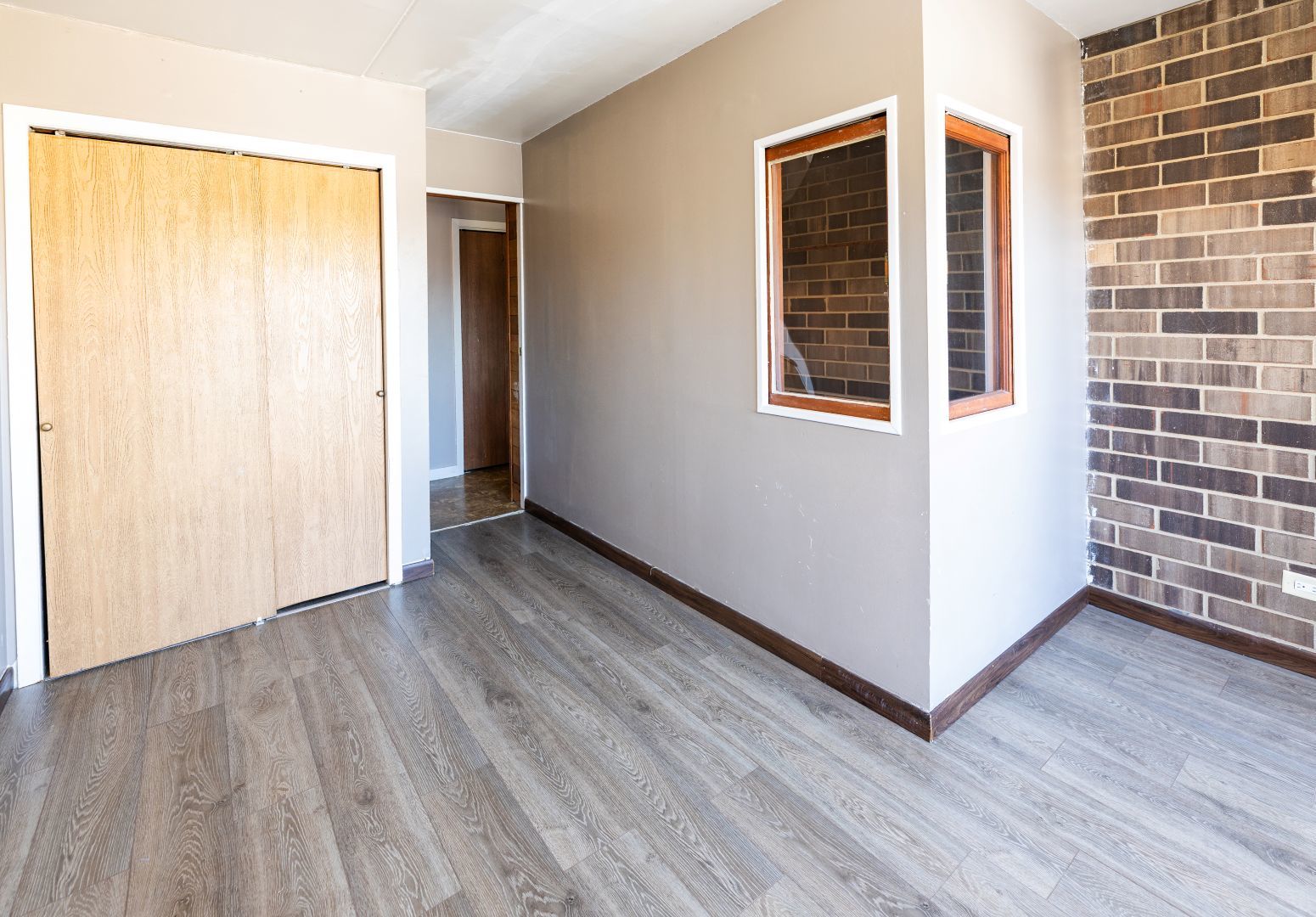 902 Kenneth Circle, Unit 6 Elgin, IL 60120 - Photo 10 of 24 a view of an empty room with wooden floor and a window