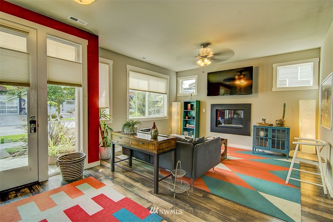 4417 Renton Avenue South Seattle, WA 98108 - Photo 2 of 21 a living room with furniture a flat screen tv and a fireplace