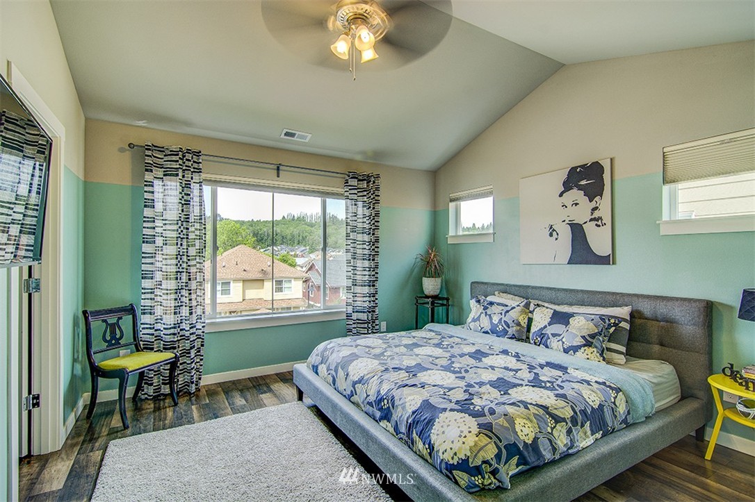 4417 Renton Avenue South Seattle, WA 98108 - Photo 12 of 21 a bedroom with a bed lamps and a large window