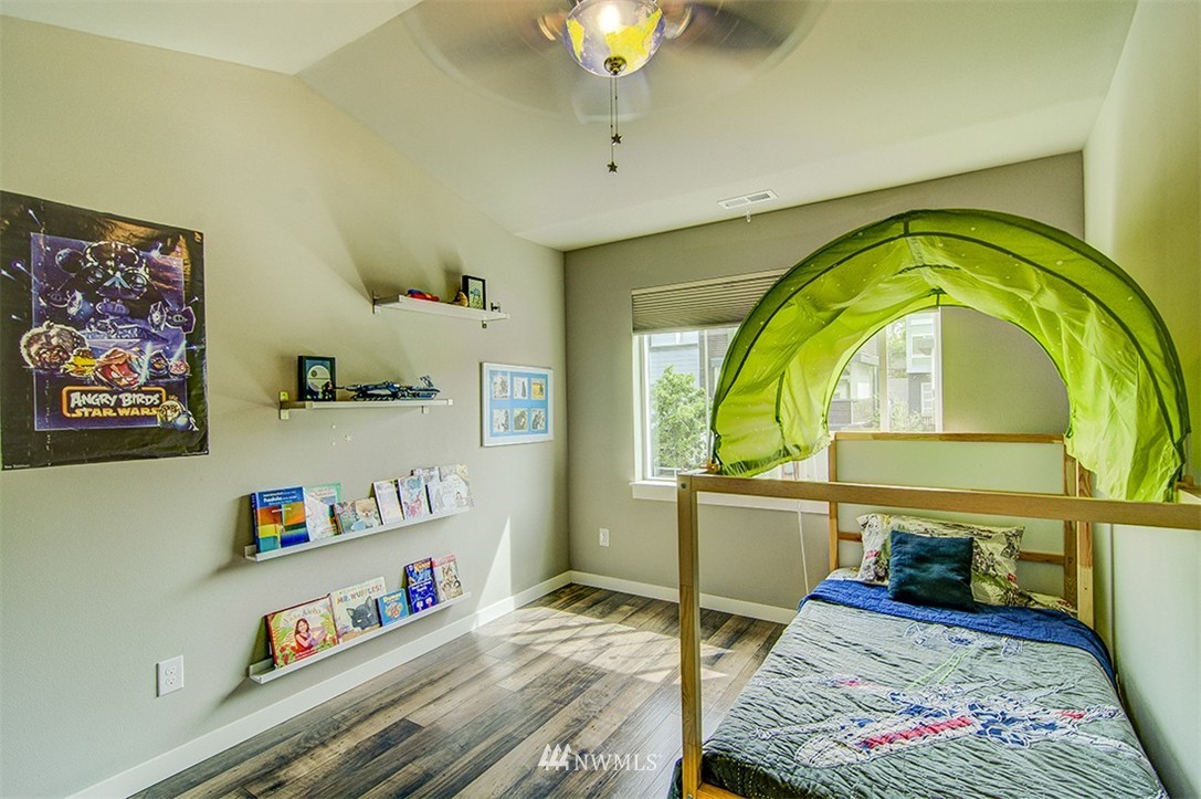 4417 Renton Avenue South Seattle, WA 98108 - Photo 16 of 21 a bedroom with bed and a chandelier