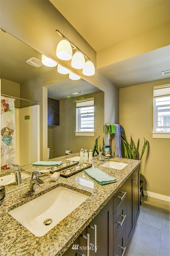 4417 Renton Avenue South Seattle, WA 98108 - Photo 18 of 21 a bathroom with a granite countertop sink and a mirror
