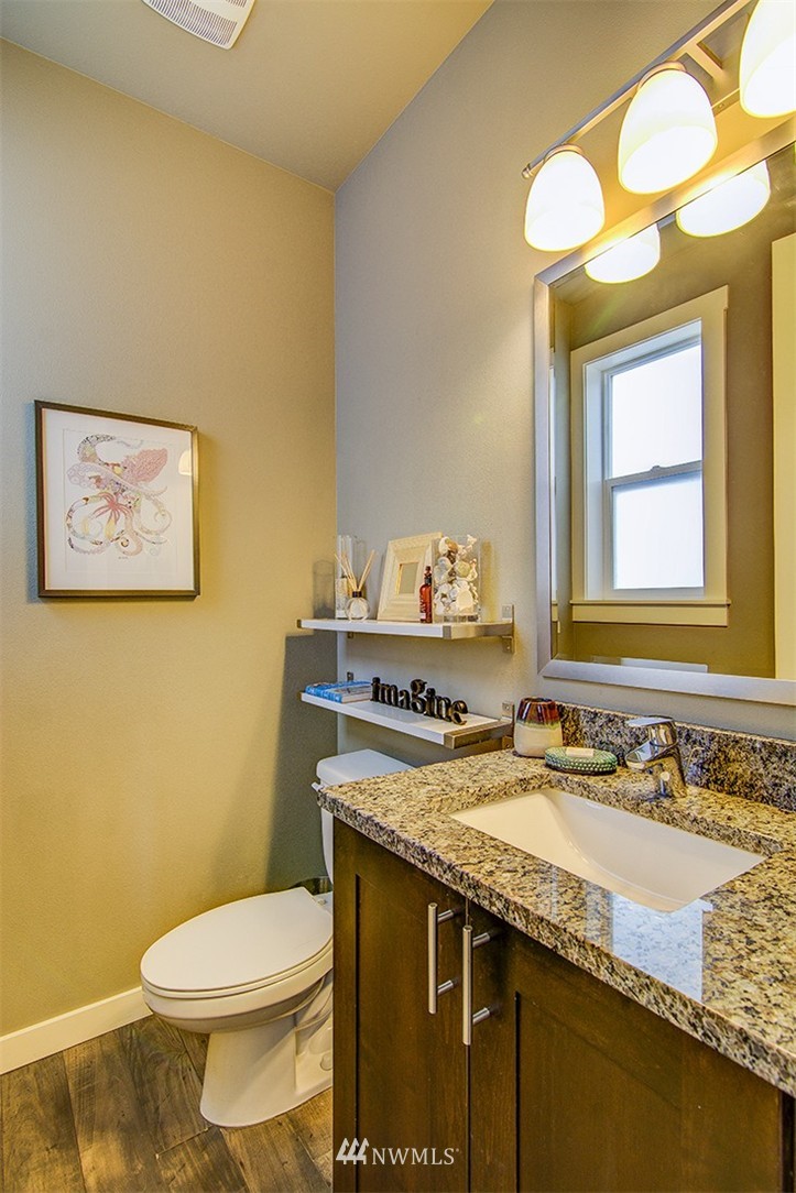 4417 Renton Avenue South Seattle, WA 98108 - Photo 9 of 21 a bathroom with a granite countertop toilet sink and mirror