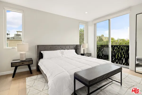 a bedroom with a bed a table and a window