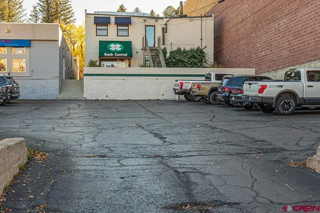 a view of a cars park in front of a building