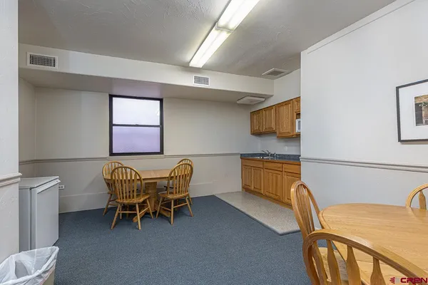 a dining room with furniture and window