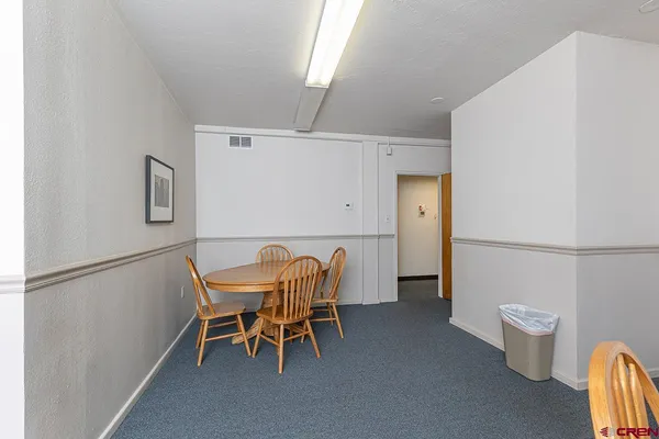 a dining room with furniture and a window