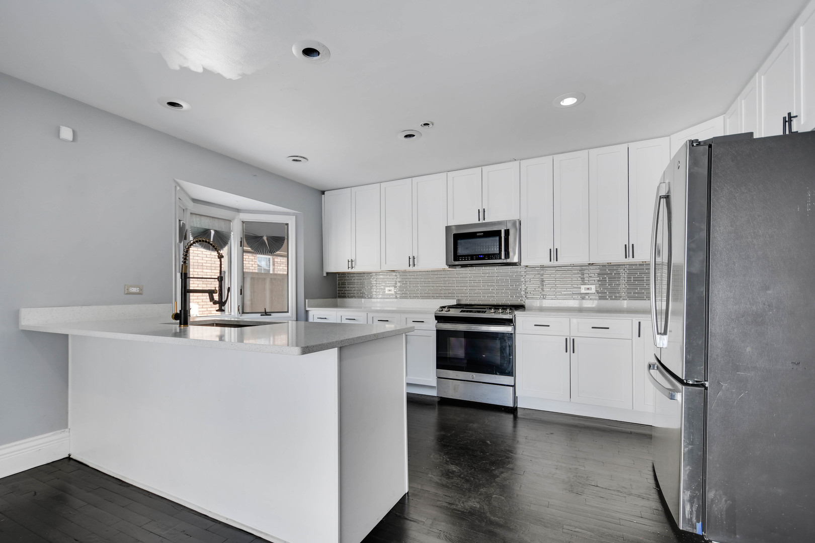 249 Milburn Avenue Crete, IL 60417 - Photo 13 of 46 a kitchen with granite countertop white cabinets and white appliances
