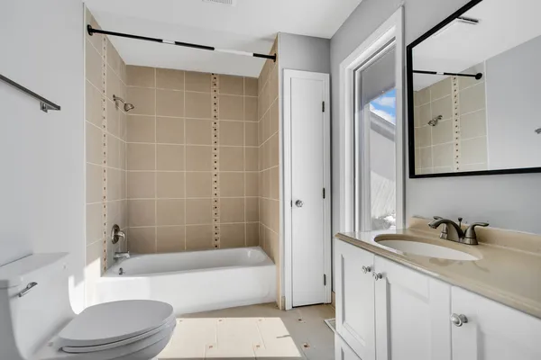 a bathroom with a sink a toilet and bathtub