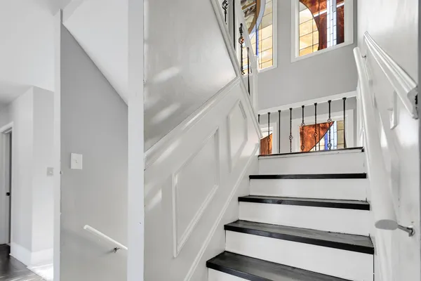 a view of staircase with wooden floor and a window