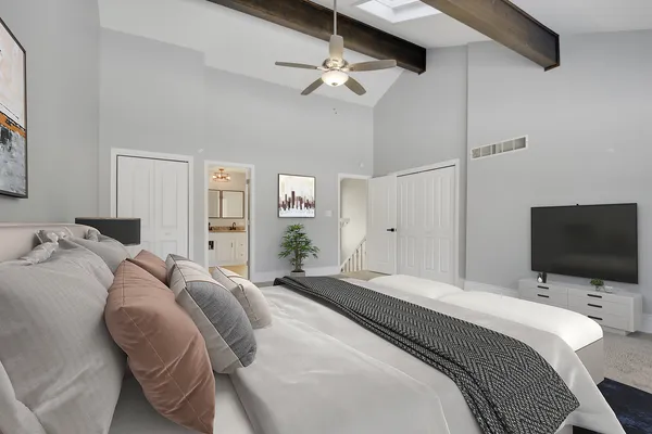a bedroom with a bed and a flat screen tv