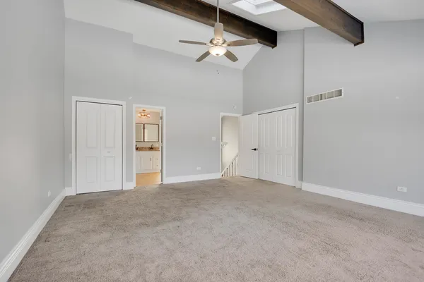 a view of empty room with ceiling fan