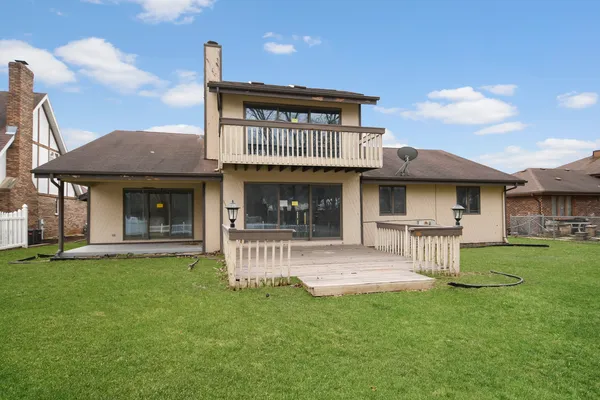 a view of a house with a yard and sitting area