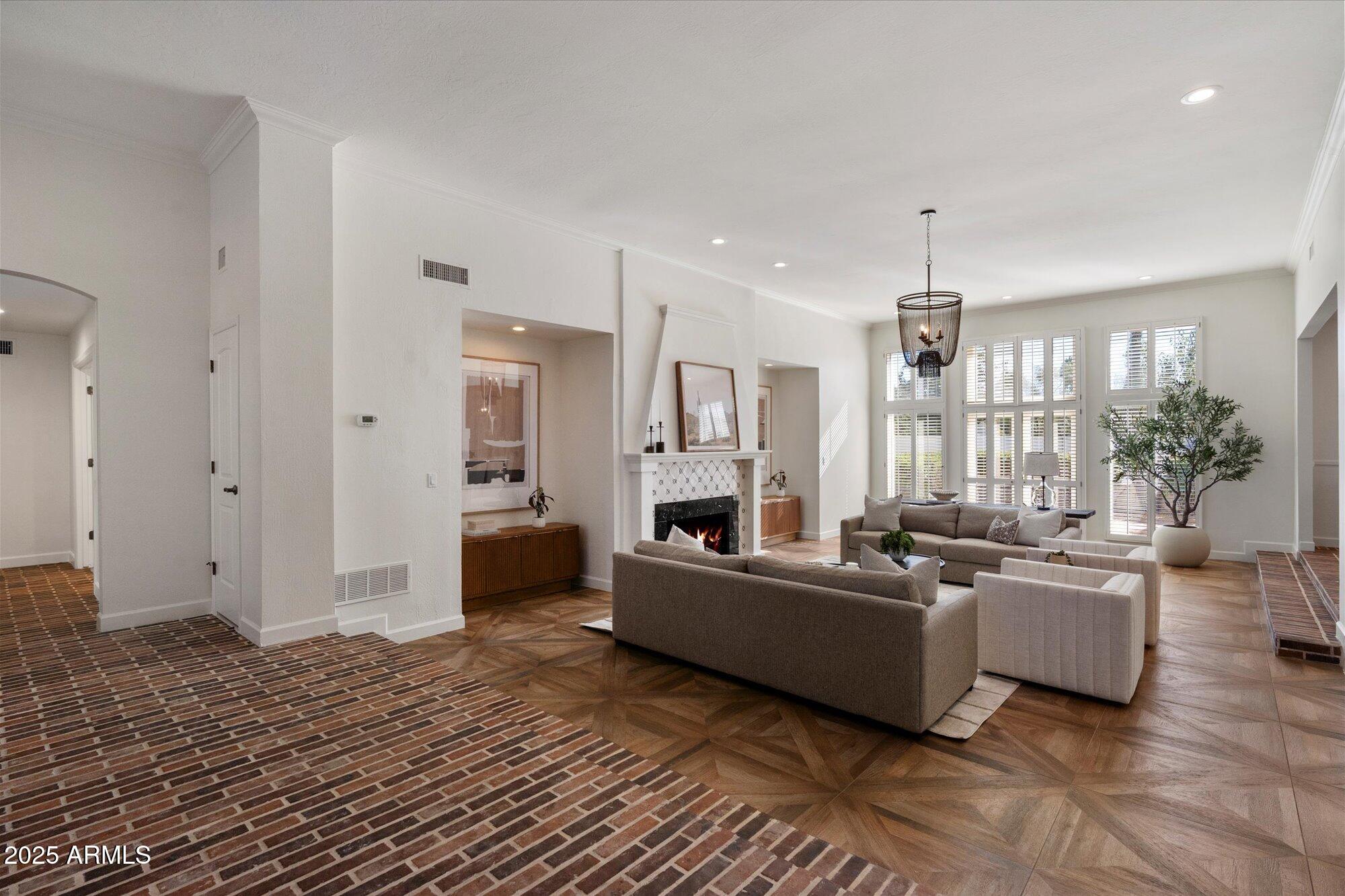 a living room with furniture and a chandelier