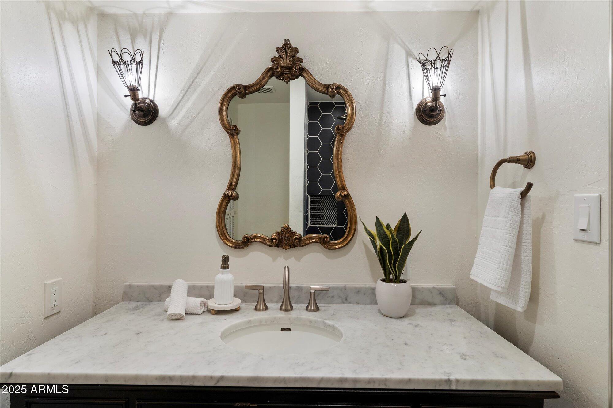 6533 East Maverick Road Paradise Valley, AZ 85253 - Photo 16 of 20 a bathroom with a sink and a mirror