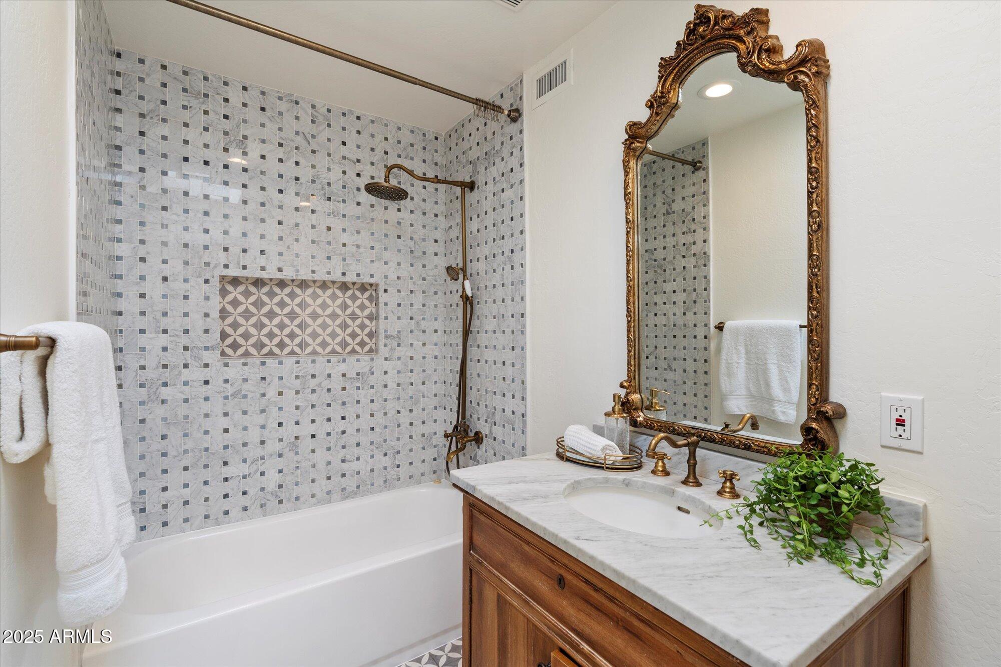 6533 East Maverick Road Paradise Valley, AZ 85253 - Photo 18 of 20 a bathroom with a granite countertop sink a toilet and shower