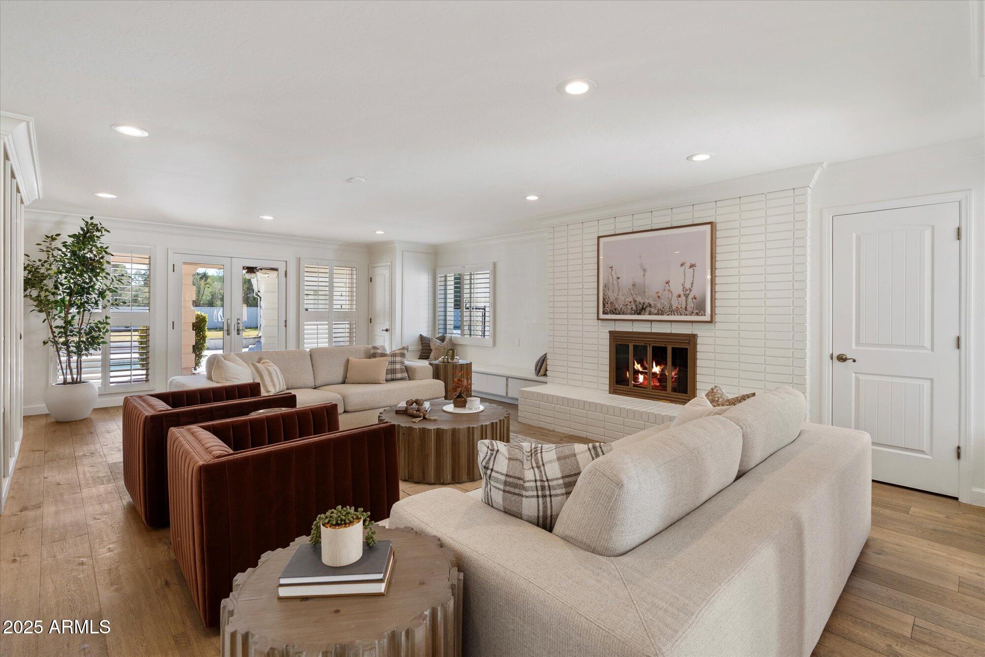 6533 East Maverick Road Paradise Valley, AZ 85253 - Photo 6 of 20 a living room with furniture a fireplace and a potted plant