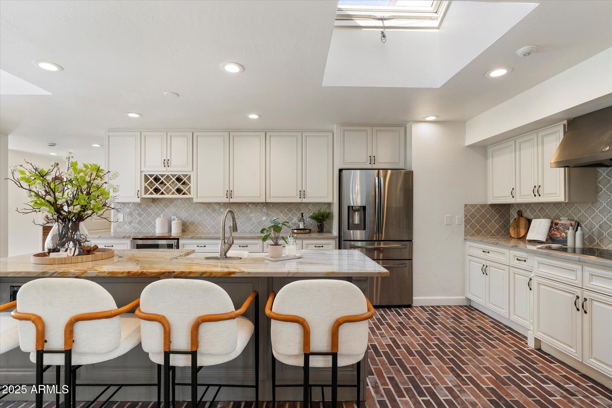 6533 East Maverick Road Paradise Valley, AZ 85253 - Photo 8 of 20 a kitchen with refrigerator and chairs