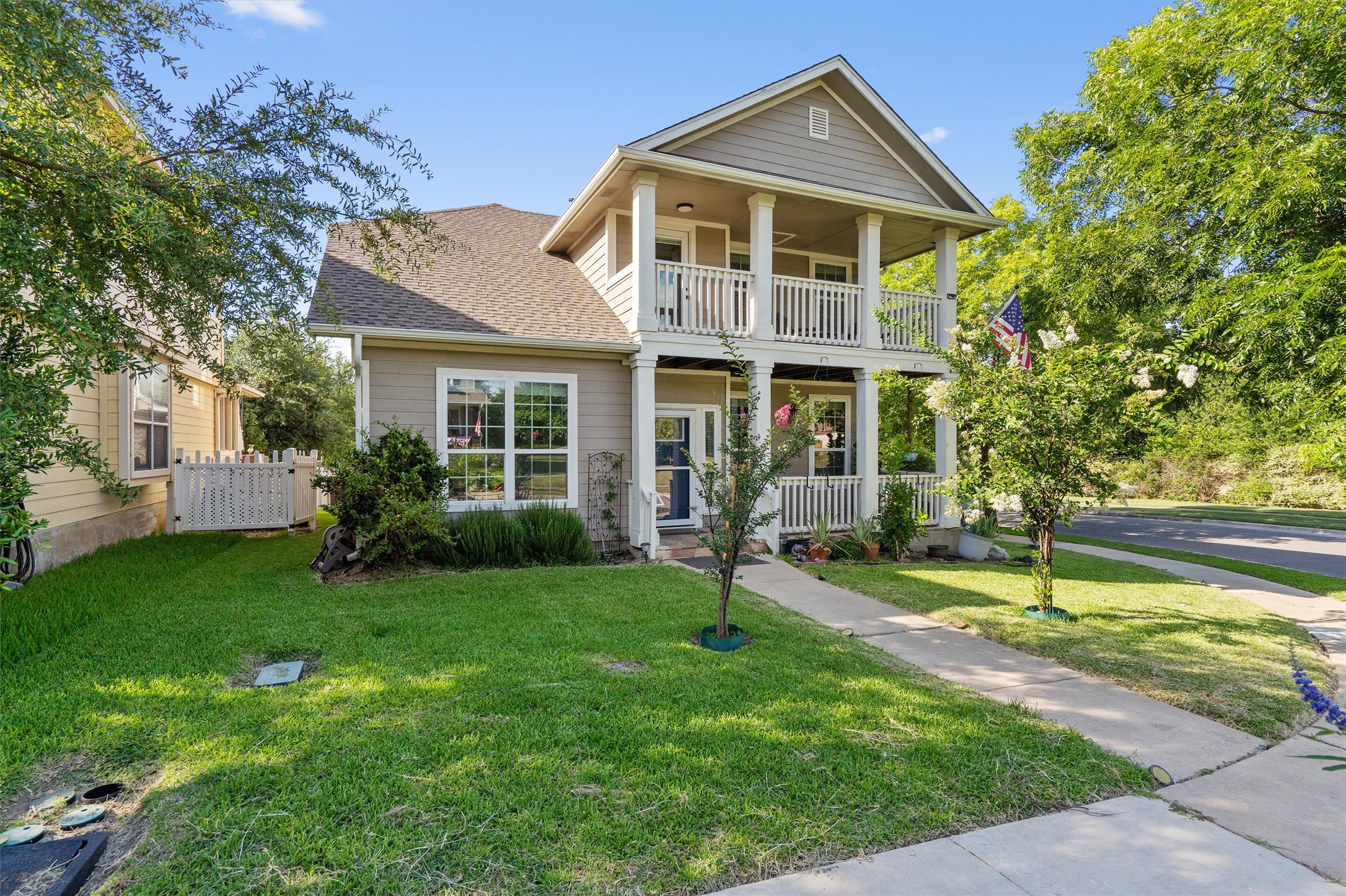 1833 Thompson Trail Round Rock, TX 78664 - Photo 2 of 40 A charming two-story home with inviting porches and lush green landscaping.