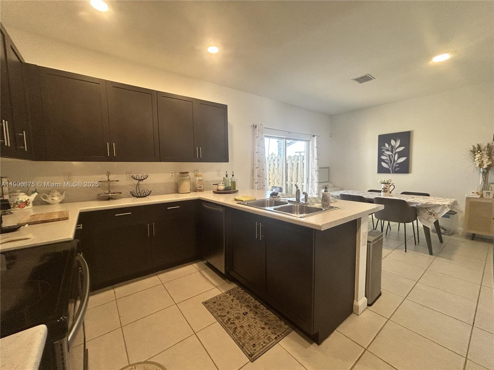 1685 Southeast 27th Street, Unit 1685 Homestead, FL 33035 - Photo 13 of 38 a kitchen with a sink and a stove top oven