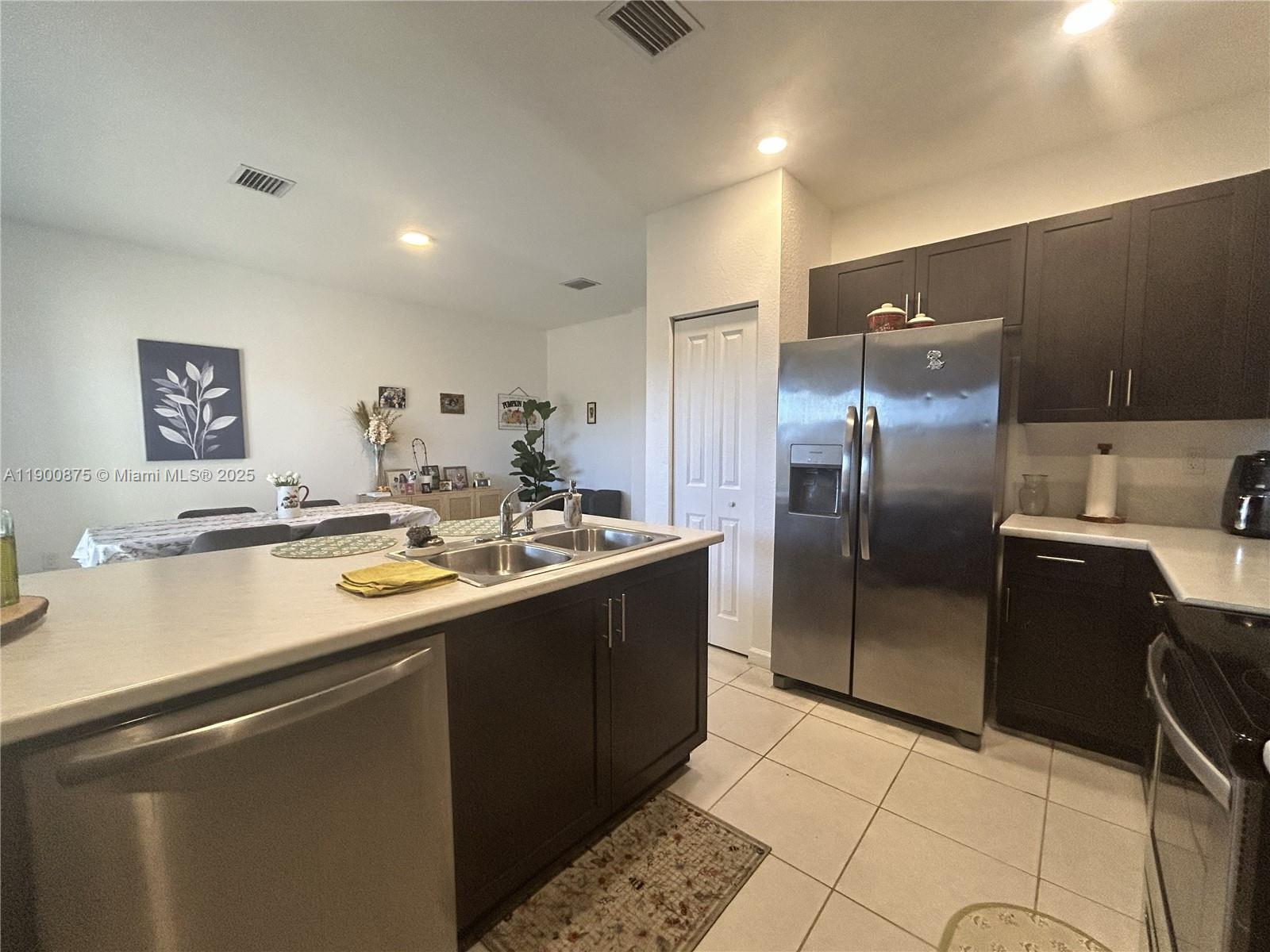 1685 Southeast 27th Street, Unit 1685 Homestead, FL 33035 - Photo 14 of 38 a kitchen with stainless steel appliances granite countertop a sink and a refrigerator