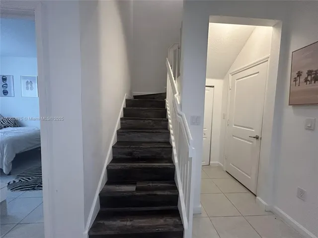 a bathroom with a sink vanity mirror and toilet