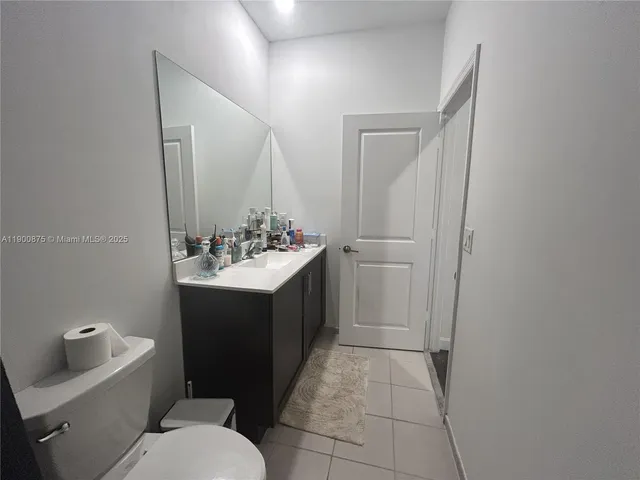 a large bedroom with a bed and furniture