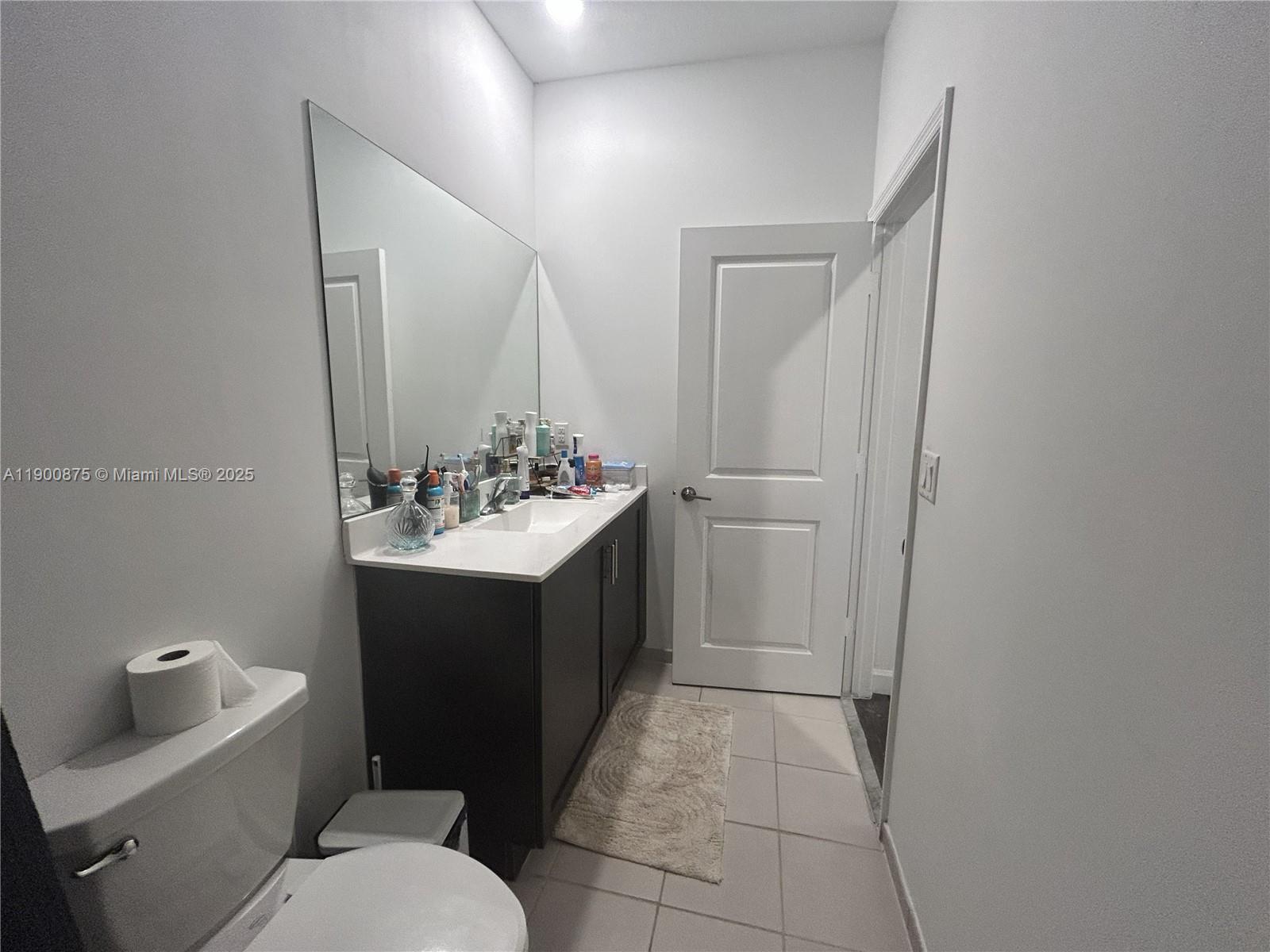 1685 Southeast 27th Street, Unit 1685 Homestead, FL 33035 - Photo 21 of 38 a bathroom with a sink vanity mirror and toilet