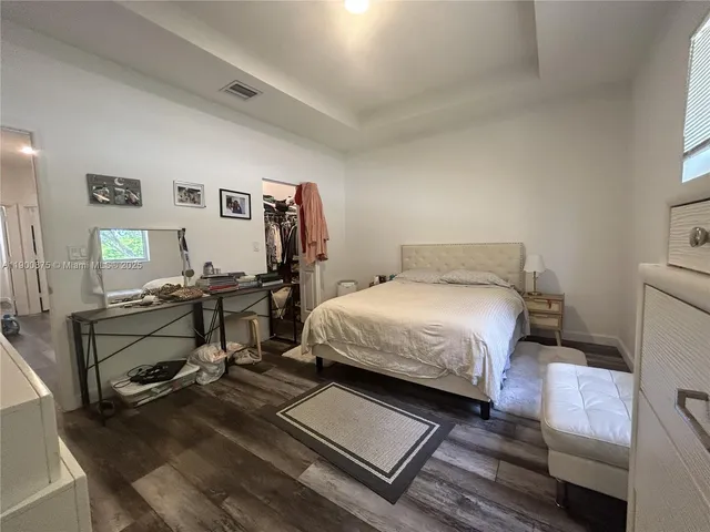 a bathroom with a double vanity sink toilet and a mirror
