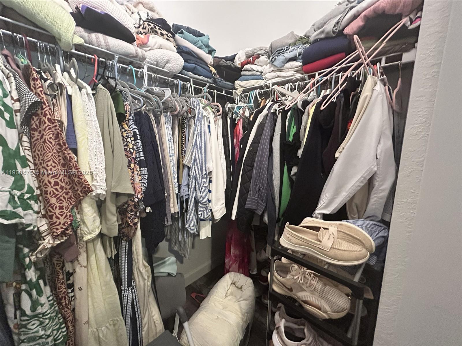 1685 Southeast 27th Street, Unit 1685 Homestead, FL 33035 - Photo 26 of 38 a view of walk in closet with clothes