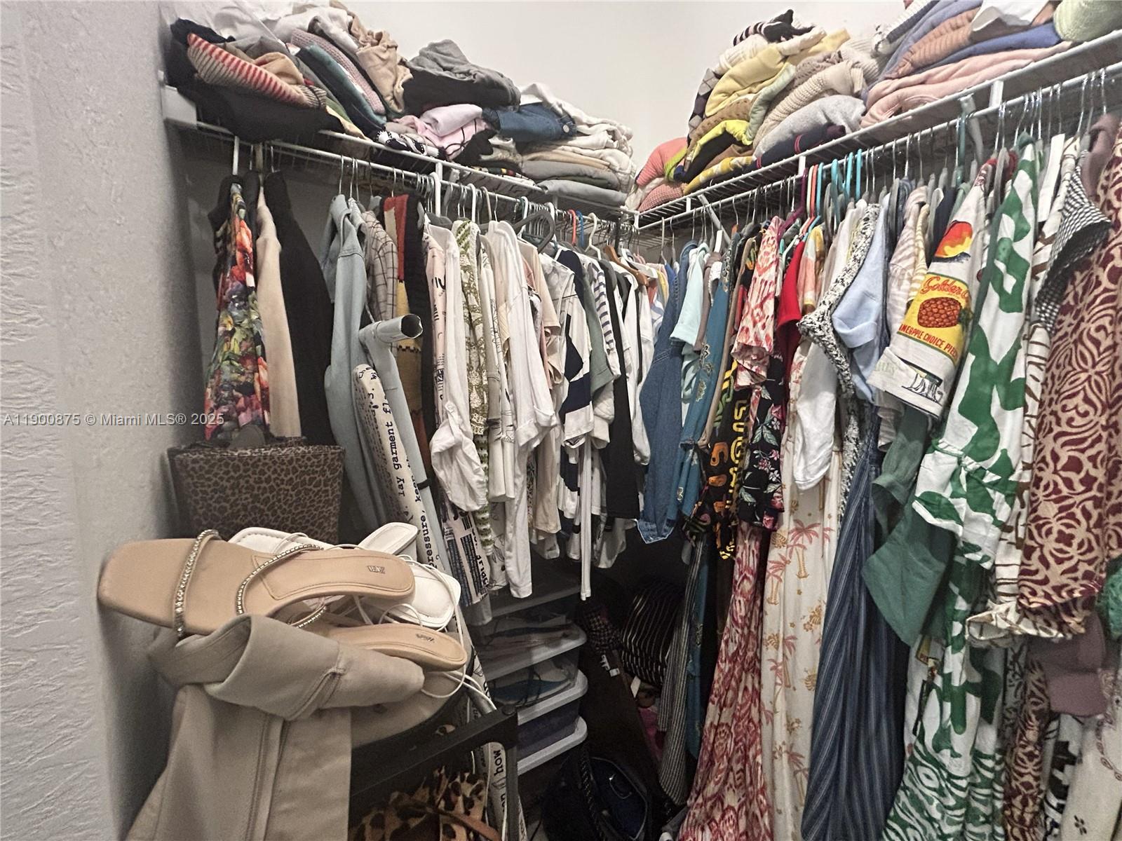 1685 Southeast 27th Street, Unit 1685 Homestead, FL 33035 - Photo 27 of 38 a view of walk in closet with clothes and shoes
