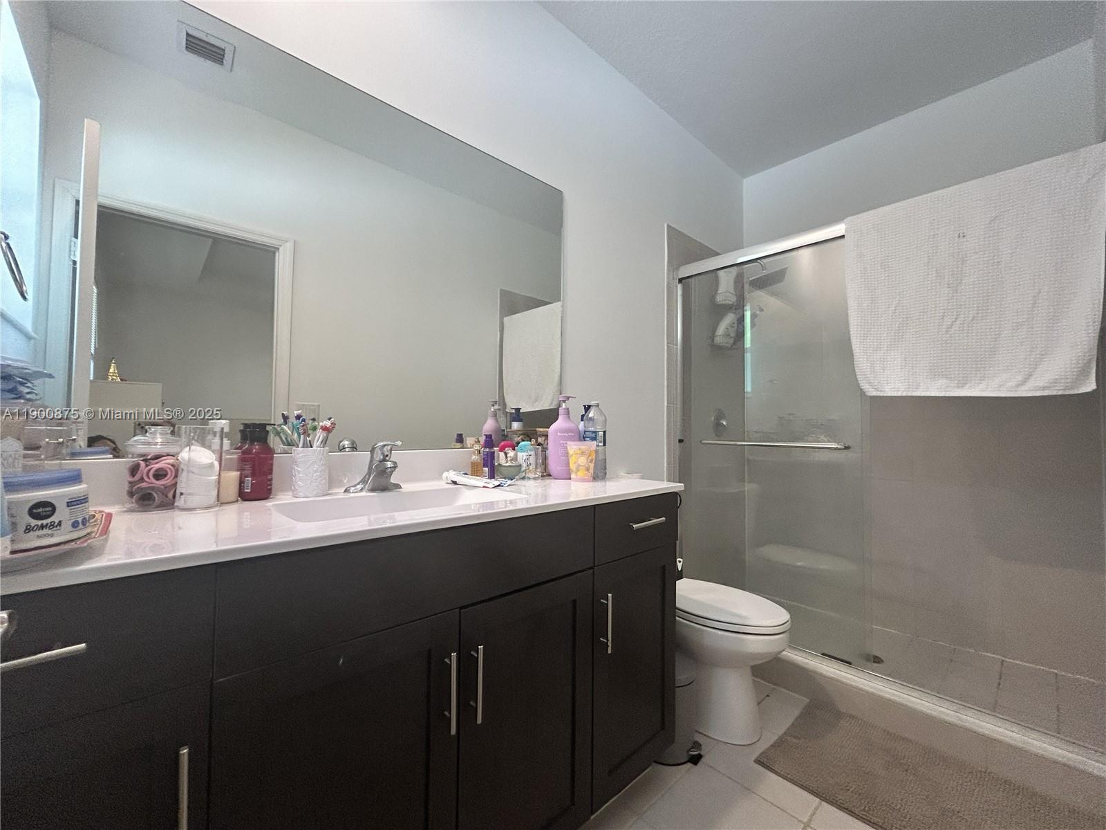 1685 Southeast 27th Street, Unit 1685 Homestead, FL 33035 - Photo 28 of 38 a bathroom with a double vanity sink toilet and a mirror
