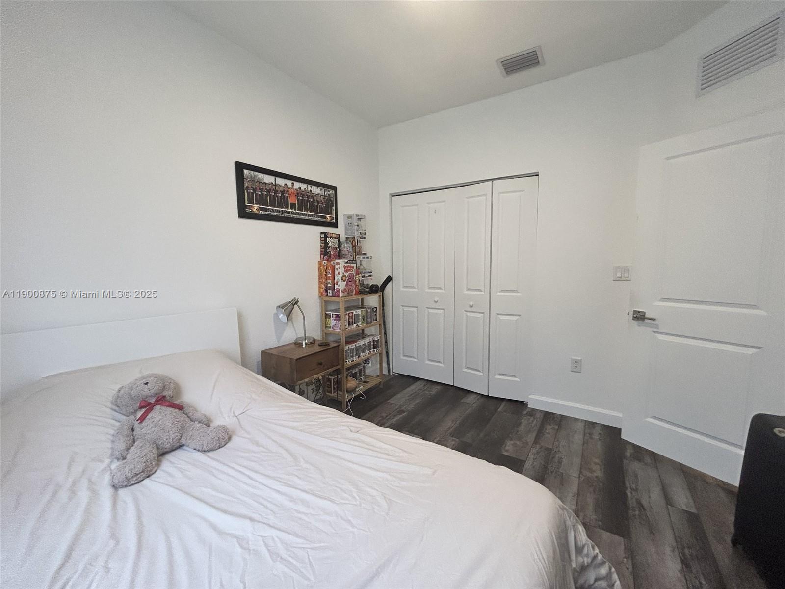 1685 Southeast 27th Street, Unit 1685 Homestead, FL 33035 - Photo 32 of 38 a bedroom with a bed and wooden floor