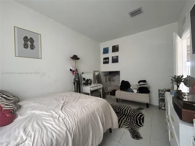 a bedroom with bed and a couch