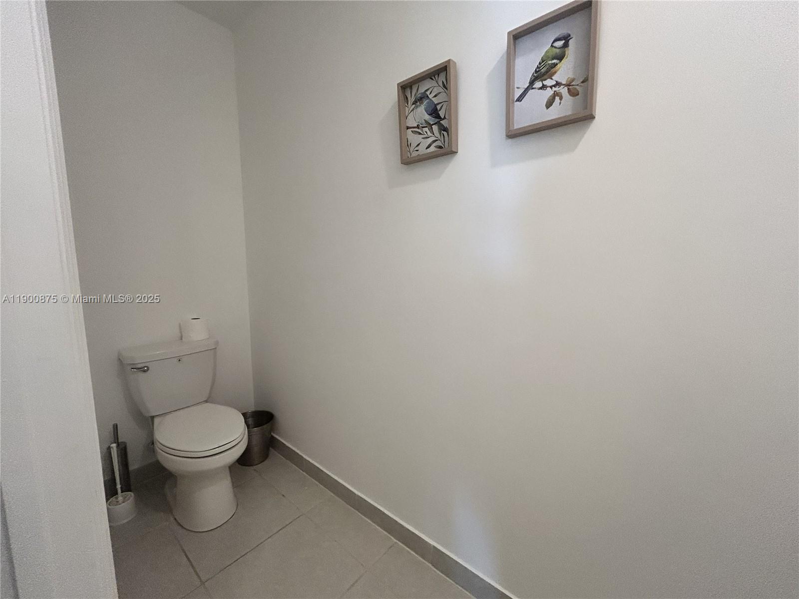 1685 Southeast 27th Street, Unit 1685 Homestead, FL 33035 - Photo 6 of 38 a white toilet sitting next to a white wall