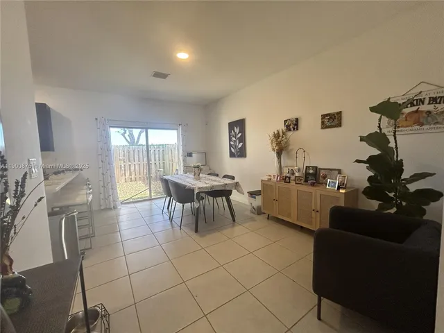 a kitchen with kitchen island a sink table and chairs