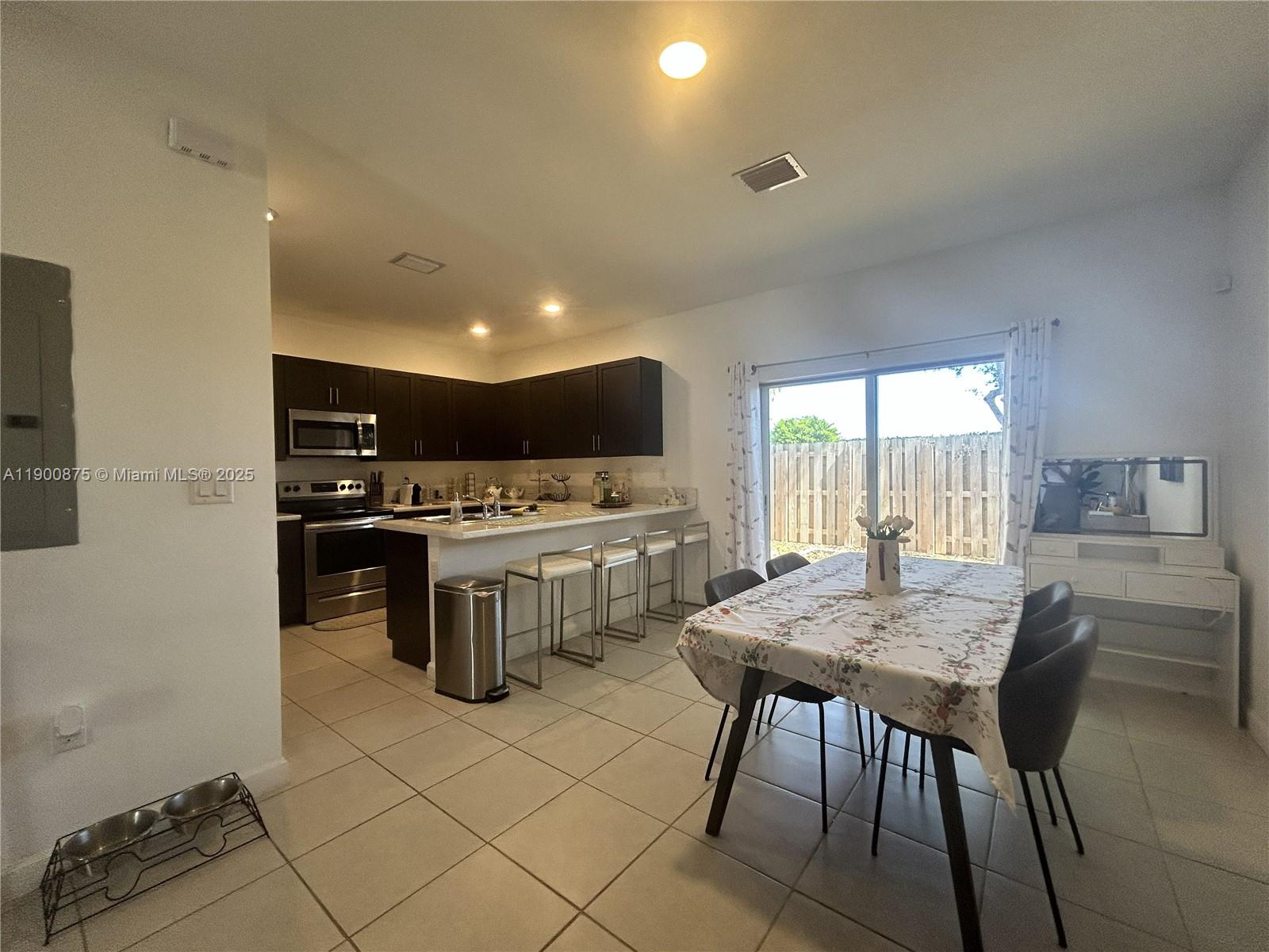 1685 Southeast 27th Street, Unit 1685 Homestead, FL 33035 - Photo 10 of 38 a kitchen that has a table and chairs in it