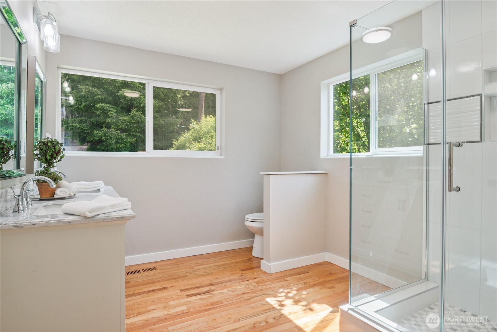 2903 Huntington Place Longview, WA 98632 - Photo 17 of 40 a bathroom with a granite countertop sink toilet and large windows