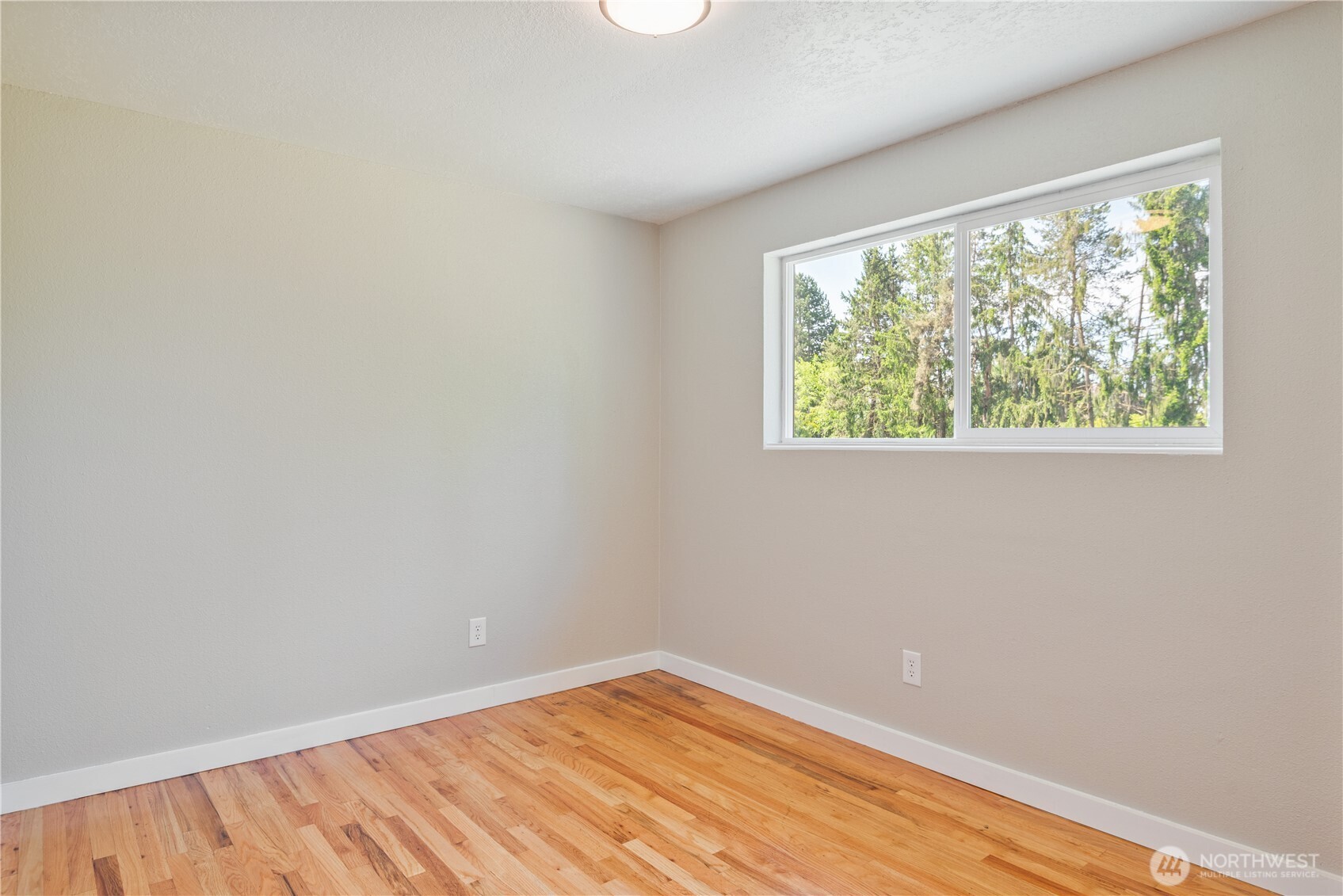 2903 Huntington Place Longview, WA 98632 - Photo 18 of 40 a view of an empty room with wooden floor and a window