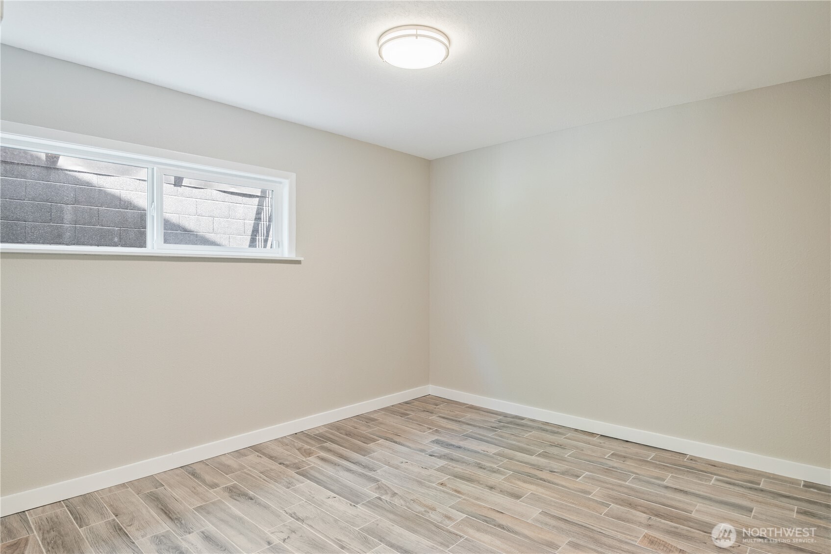 2903 Huntington Place Longview, WA 98632 - Photo 24 of 40 a view of an empty room with wooden floor and a window