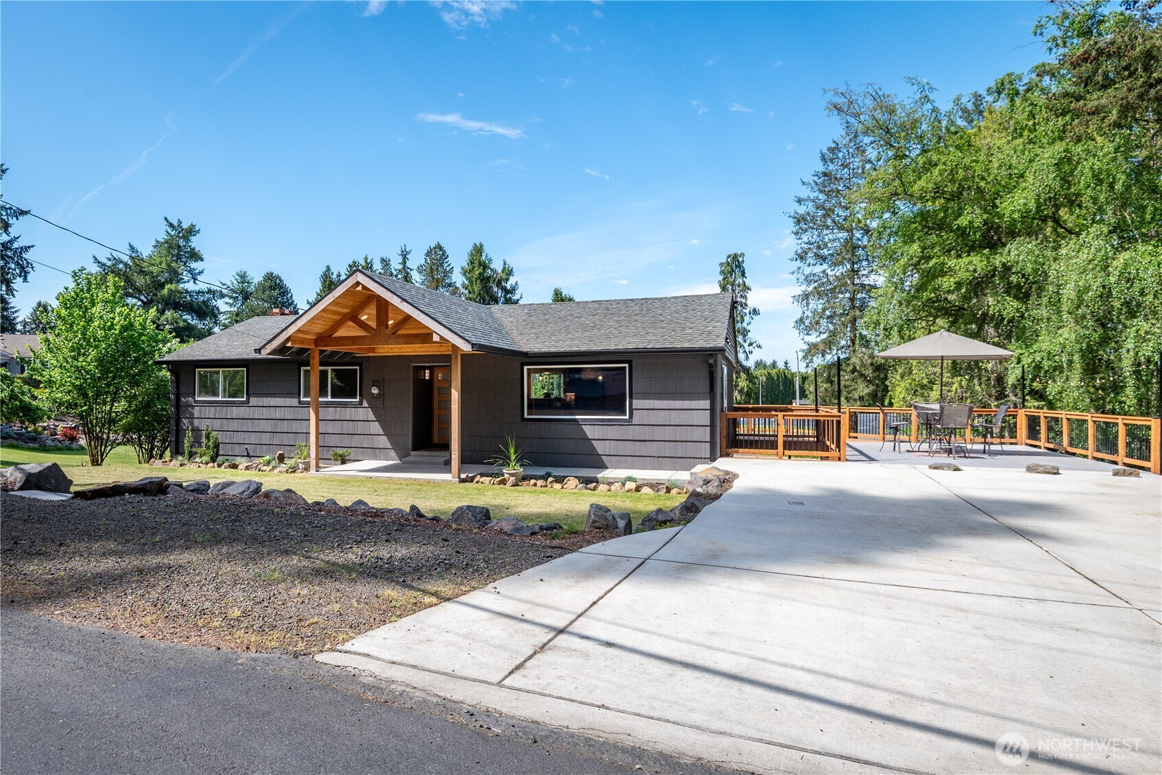 2903 Huntington Place Longview, WA 98632 - Photo 25 of 40 a patio with a table and chairs under an umbrella